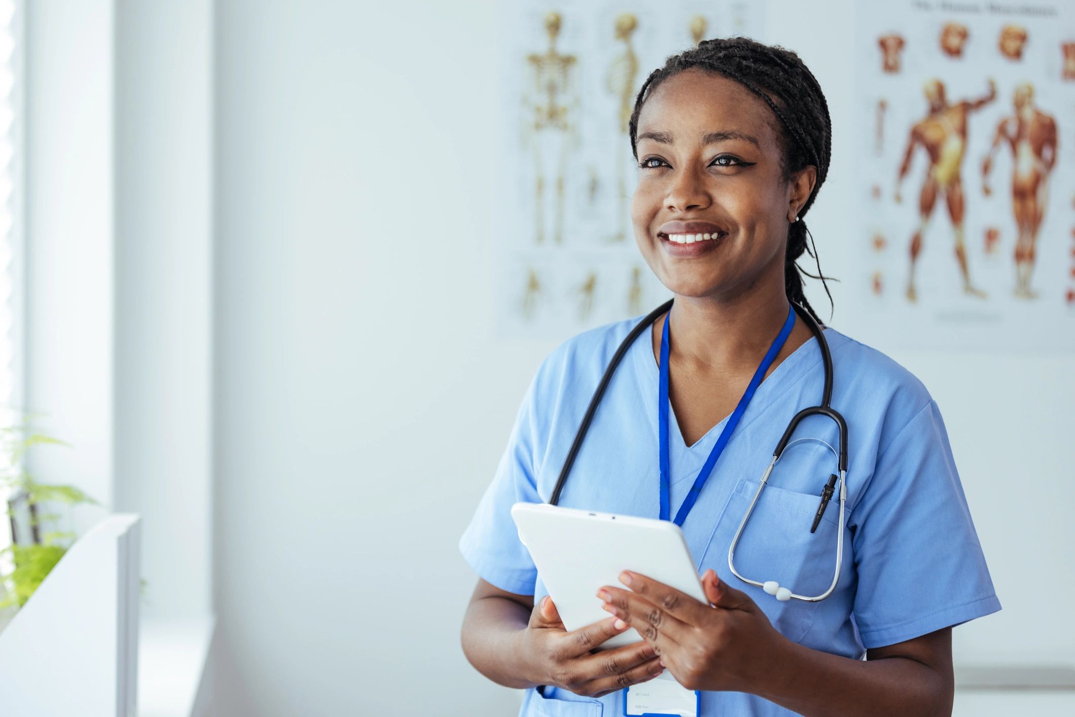Healthcare practitioner holding a digital tablet in a clinic