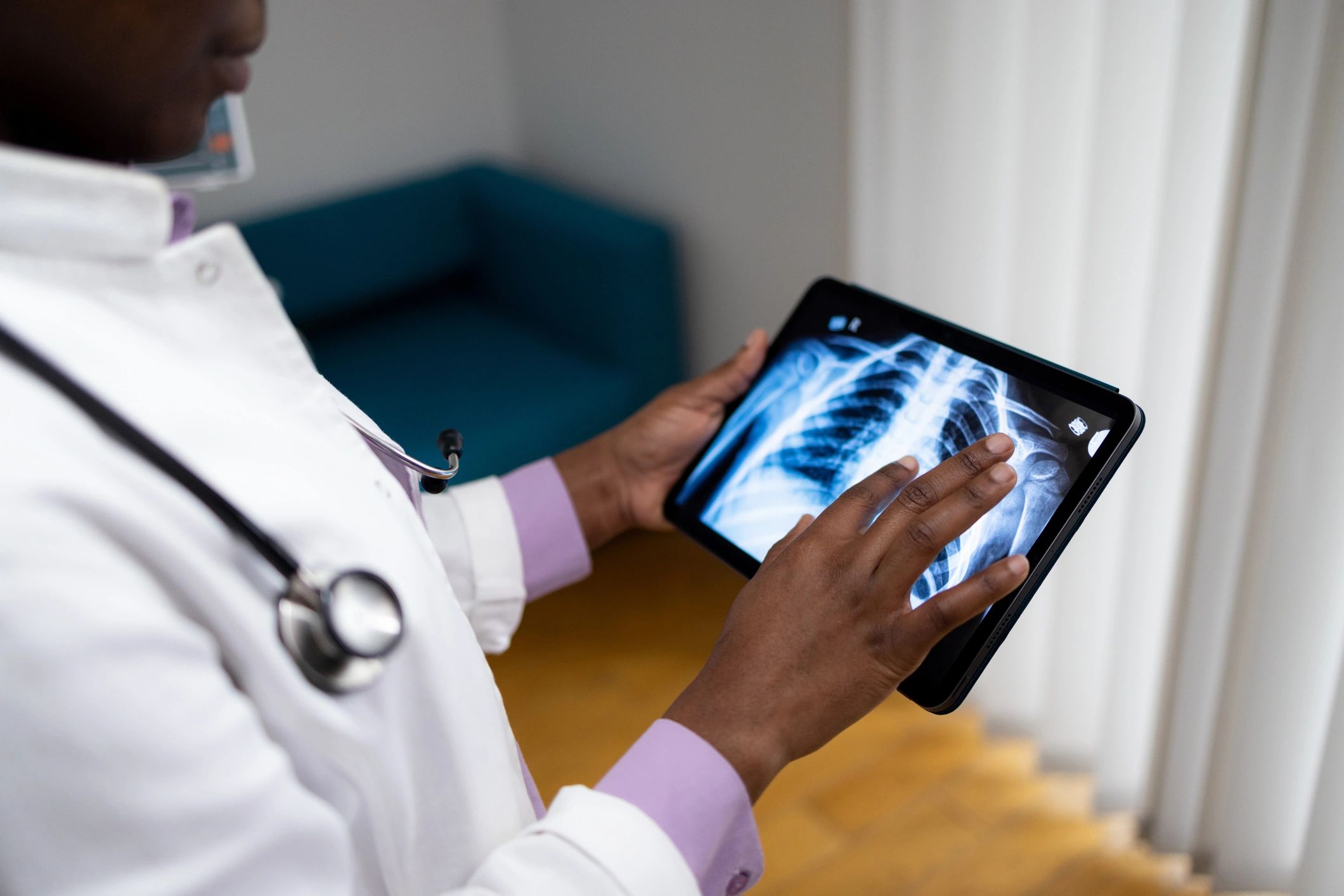 Doctor reviewing a medical scan on a tablet