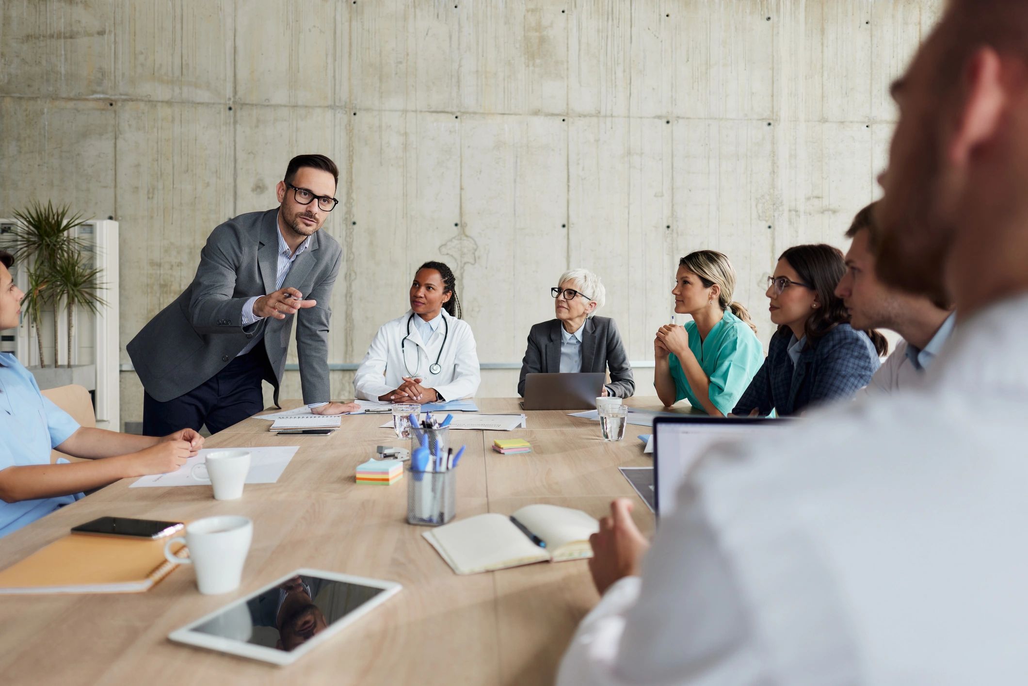 Healthcare leadership meeting in a hospital conference room