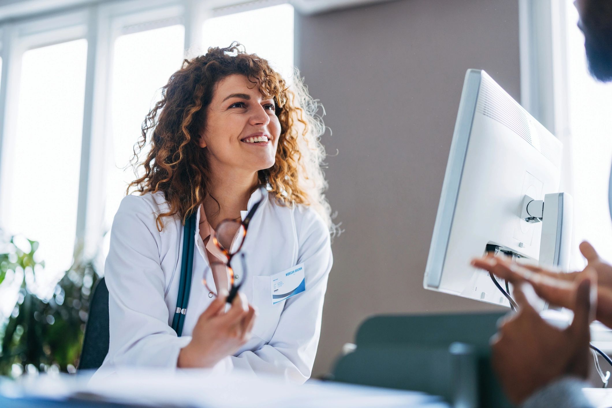 Clinician speaking with a patient during a consultation